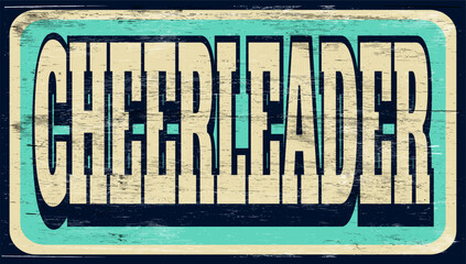 Aged and worn cheerleader sign on wood