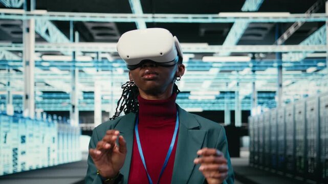 Data center female engineer putting VR glasses on to do gear rigs optimization. African american woman in server room using virtual reality and pinch zoom hand gestures to upgrade mainframes, camera A