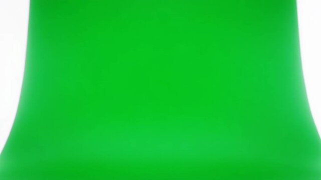 A close-up view of a vibrant green object resembling a cone or bell shape