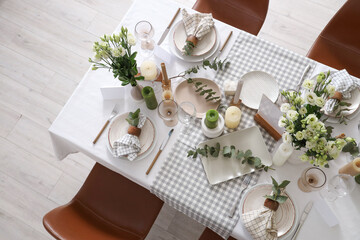 Beautiful table setting with eustoma flowers and eucalyptus for wedding celebration in room, top view © Pixel-Shot