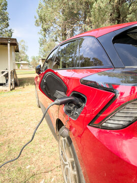 EV electric car plugged in and charging at a rural holiday remote camping site