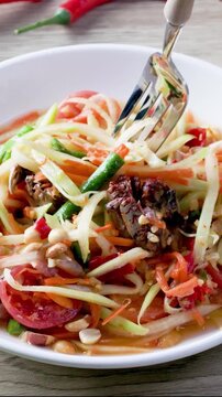 Somtum - Thai spicy papaya salad with herring