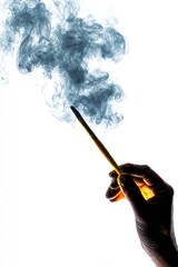 Hand holding glowing wand, releasing wisps of dark smoke