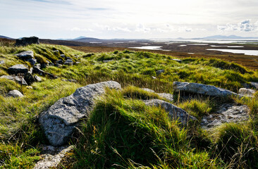 Clettraval wheelhouse prehistoric site on S slope of South Clettraval, N. Uist. SE from interior over coast to Beinn Mhor, S. Uist on horizon right © David Matthew Lyons