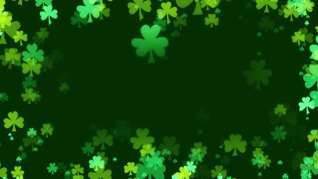 St Patricks day background with a frame of shamrocks in various greens floating towards center. Clover leaf particles forming a border for a green background to celebrate St Patrick day.