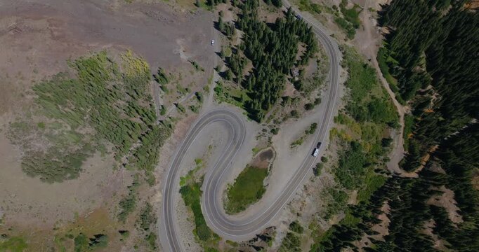 Overhead aerial of dramatic switchback curves carved into steep Colorado mountainside, Million Dollay Highway Colorado USA