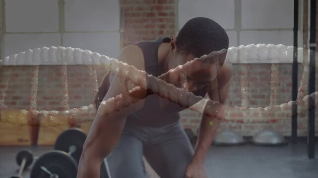 Man reaching for dumbbell, doing bent-over rows, pausing, sitting, braided rope over for fitness