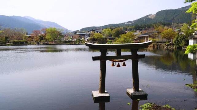 Kinrin lake in Yufuin town, Kinrin-ko lake, Oita prefecture, Japan, hot spring onsen resort town, with mount Yufu, Kyushu island region, rural mountain landscape, a spring day with a blue sky