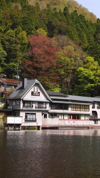 Kinrin lake in Yufuin town, Kinrin-ko lake, Oita prefecture, Japan, hot spring onsen resort town, with mount Yufu, Kyushu island region, rural mountain landscape, a spring day with a blue sky