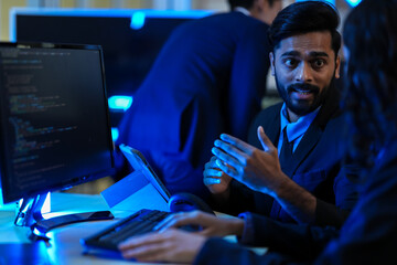 Cybersecurity analysts executing threat mitigation protocols in security operations center. IT specialists monitoring network firewall intrusion detection systems.