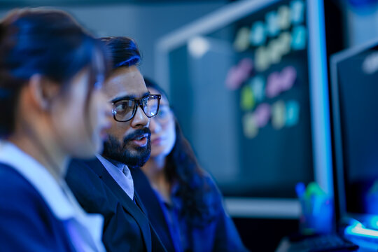 Enterprise architects mapping digital transformation roadmap milestones on glass wall. Strategic executives analyzing organizational kpi objectives via visual diagramming.