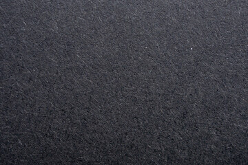 Fototapeta premium Black paper texture background with rough fiber surface and dark grey cardboard pattern