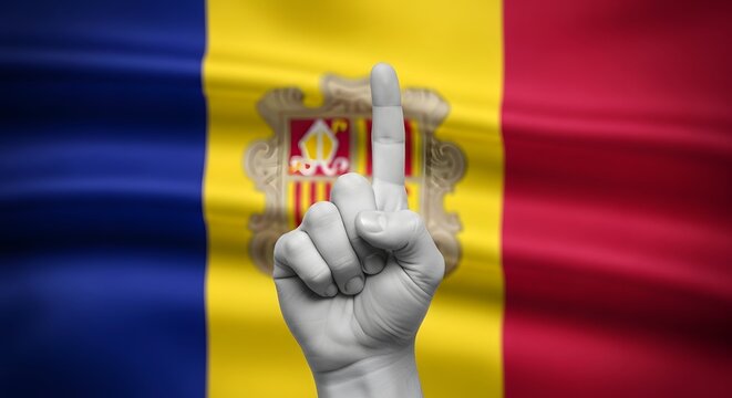A black and white hand giving an offensive middle finger gesture against the waving flag of Andorra.
