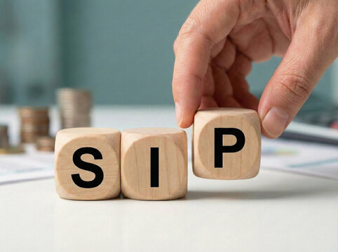 systematic investment plan concept with wooden sip blocks and hand placing final cube on white desk symbolizing disciplined investing mutual funds and wealth creation