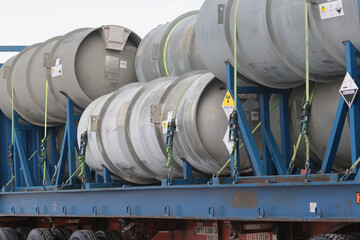 Workers and trucks and factory at a Uranium Processing plant.  © Janet