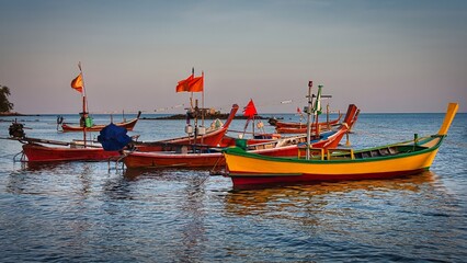 Naklejka premium Long tail fishing boats early morning at the southern end of Bang Tao Beach, Phuket, Thailand
