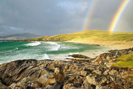 Nisabost Beach at Traigh Iar between Borve and Seilebost on Harris. View north to island of Taransay behind. Outer Hebrides, Scotland. Double rainbow