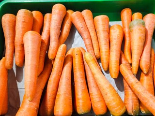 Close-up top view of a bunch of fresh carrots or Daucus carota