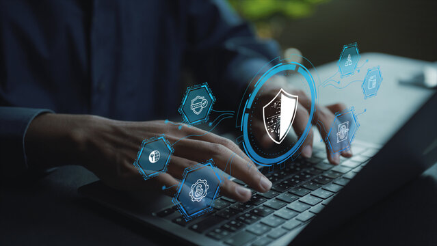 Digital cyber security concept. Person working on laptop with firewall, encryption and shield icons, hacking prevention, data privacy and IT security management.