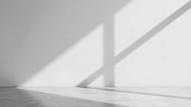 Minimal interior room with diagonal sunlight shadow white wall and floor casting geometric shadow