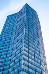 Fototapeta premium Modern skyscraper facade with curved glass architecture