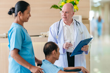 Obraz premium Medical Team Assisting Male Patient in Wheelchair