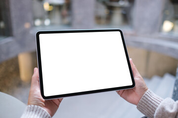 Mockup image of a woman holding digital tablet with blank white desktop screen