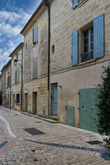 Uzes in France, old facades in the historic center, typical street
