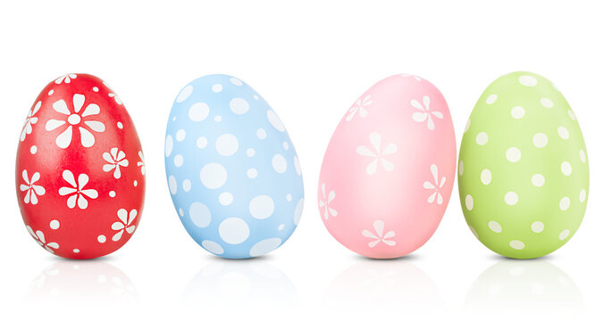 four painted Easter eggs standing on a white isolated background
