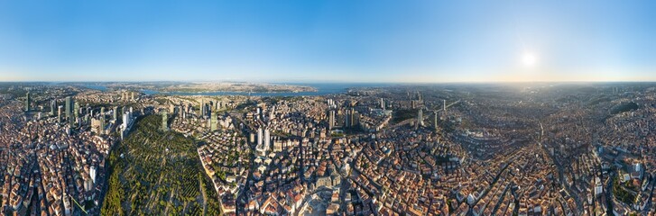 Obraz premium Istanbul, Turkey. Panoramic aerial drone view of Bosphorus Strait and European district skyline with modern skyscrapers at sunset, clear sky, golden hour. Panorama 360. Aerial view