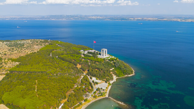 Eceabat, Turkey. Dardanelles Strait, coastline, Canakkale Martyrs Memorial, Turkish flag, Hisarlik Hill, clear day, drone. Aerial View