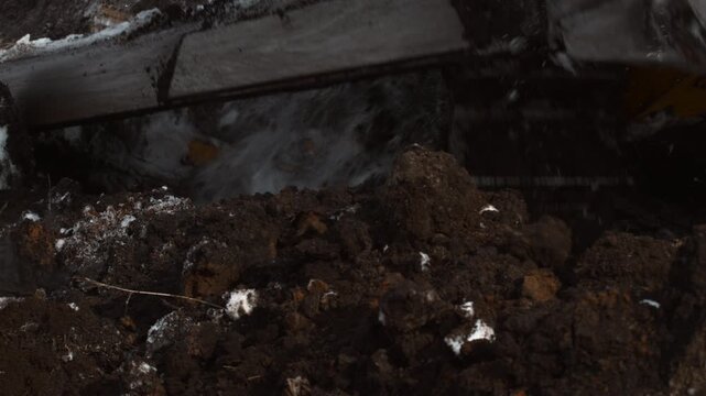 Detailed Perspective Of Wet Muddy Earth And Snow Congested With Construction Equipment Atmosphere . Stock clip