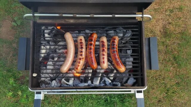 Delicious sausages are cooked on a grill.