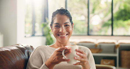 Coffee, home and portrait of happy woman on sofa with drink for wellness, calm and relax in living...