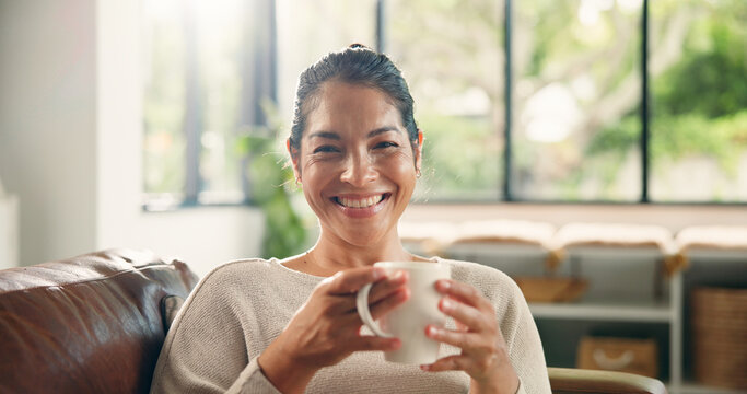 Coffee, home and portrait of happy woman on sofa with drink for wellness, calm and relax in living room. Rest, house and person smile with beverage on couch for peaceful, me time and break on weekend