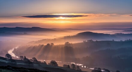 Sunrise over rolling hills and misty valleys.