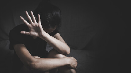 Naklejka premium stop violence against Women. A woman holds up her hand in a stop gesture, looking distressed, symbolizing the fight against violence and abuse. ,sexual abuse, human trafficking