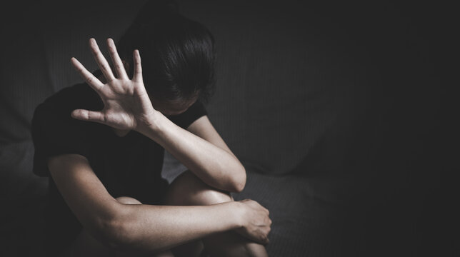 stop violence against Women. A woman holds up her hand in a stop gesture, looking distressed, symbolizing the fight against violence and abuse. ,sexual abuse, human trafficking