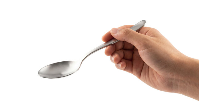 Stainless steel spoon held by hand, silver metal cutlery, kitchen utensil on white background
