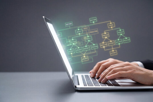 Data scientist typing on a laptop with a glowing flowchart hologram showing an algorithm