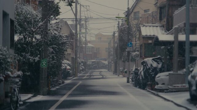 Snow dusting rooftops and sidewalks in Setagaya.