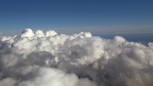 hyperlapse taken from a jet cockpit while flying over a layer of cottony clouds, doing some abrupt turns.