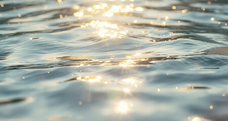 Sunlit turquoise ocean reflecting sunlight with puffy clouds in bright blue sky  © mari