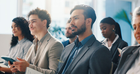 Audience, businessman and listening to seminar with notebook for finance expo, learning or speech. Convention, crowd and male person with attention, knowledge and notes for wealth management training © WesJVR/peopleimages.com