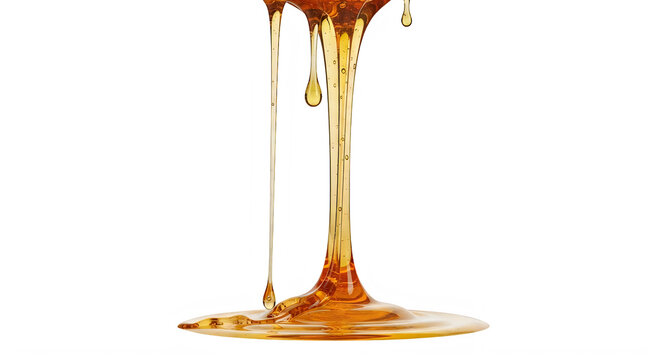 Golden honey slowly dripping from a small container onto a surface