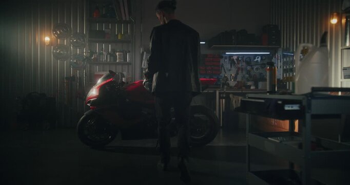 Male Rider in Black Leather Jacket Prepares For Night Ride. Once Seated, Man Assumes Aerodynamic Stance, Gloved Hands Ready Turn Ignition and Bring Powerful Machine Life. Man and Machine. Slow Motion.