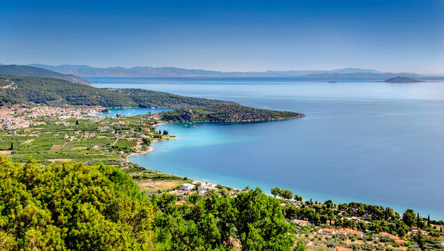 view on the peloponese coast and  to seaside resort of Archai Epidavros (Epidaure) with beautiful blue water  under clear sky in Greece