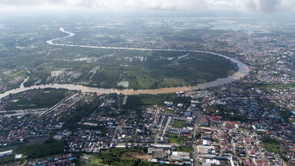 Fototapeta premium Aerial view of wide river flow and village view of Banjarmasin, South Kalimantan