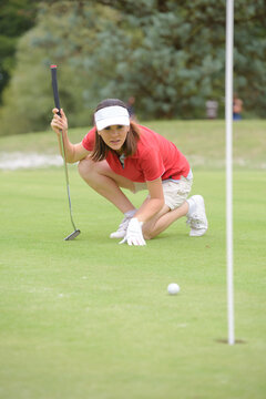 woman golfer feeling disappointed after golf ball missed the hole
