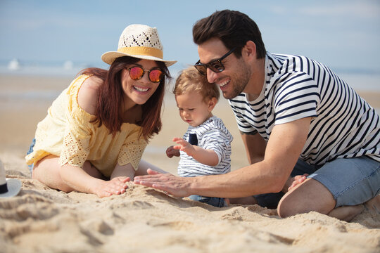 mother father and baby feet at the sea f
